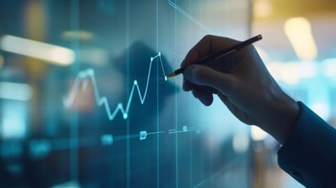 hand drawing a digital line graph on a wall with a stylus