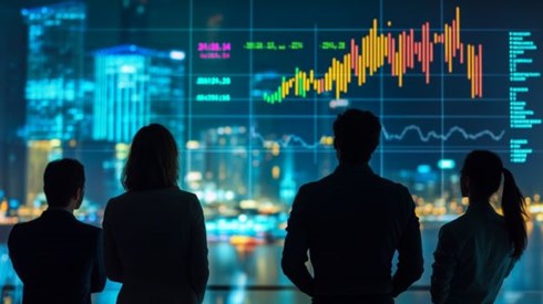 silhouettes of four businesspeople looking at charts and graphs projected on a screen