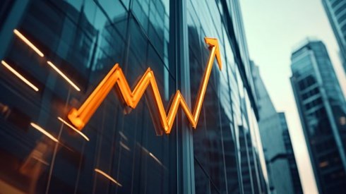 orange line graph arrow going up over commercial buildings