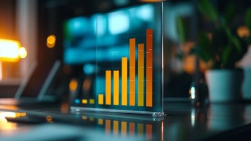 red yellow and green bar chart increasing printed on a glass stand on an office desk