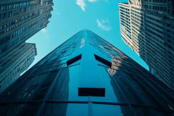 large blue arrow going up the side of a professional building