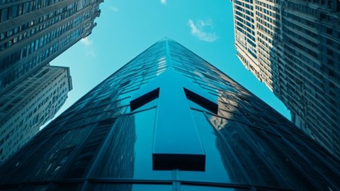 large blue arrow going up the side of a professional building