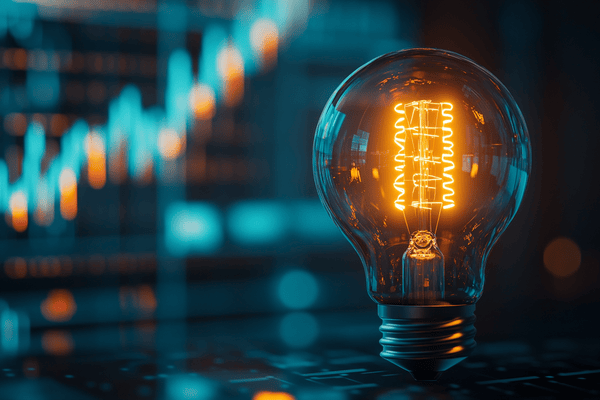 A lightbulb in front of an increasing line graph