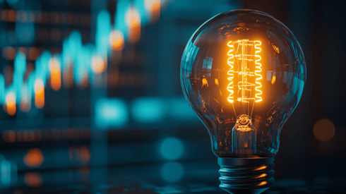 A lightbulb in front of an increasing line graph