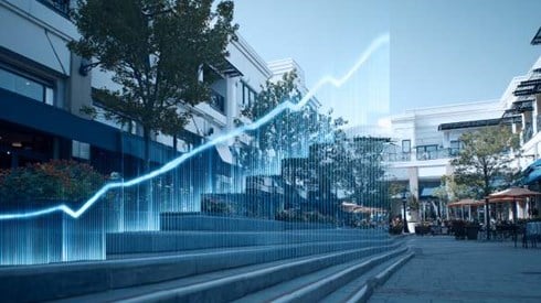blue line graph going up over a staircase in an outdoor shopping center