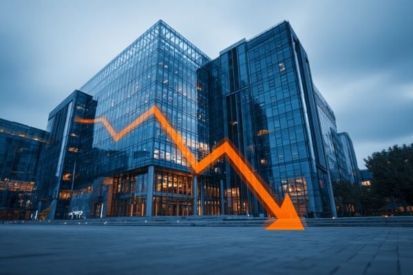 tall commercial building in blues with an orange decreasing line graph and arrow superimposed over the top