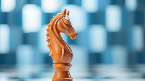 Orange Knight Chess Piece on a Chess Board with Blurry Blue and White Checkerboard in Background