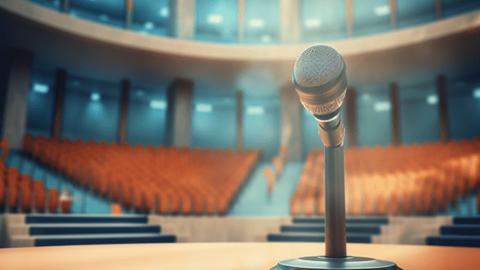 Microphone sitting on table in lecture hall