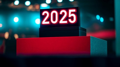 The number 2025 on a red and black podium in an auditorium