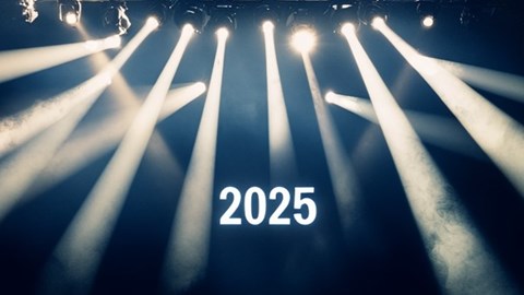 The number 2025 with stage lights shining around it