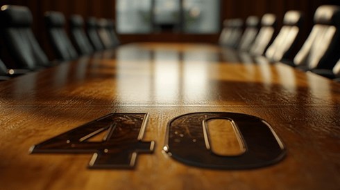 The number 40 embossed in a wooden conference table