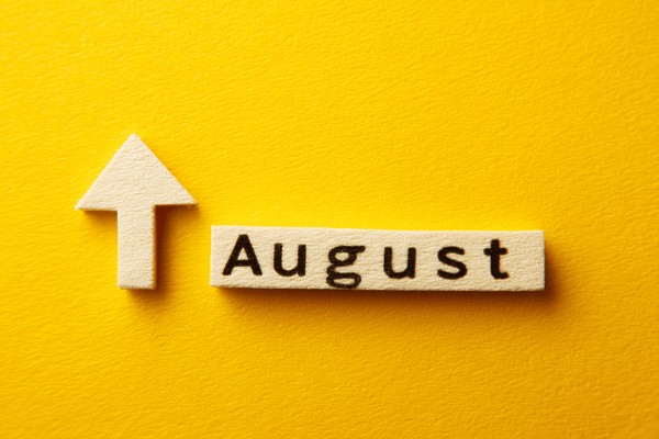 An arrow pointing upward on the left of "August" on a bright yellow background