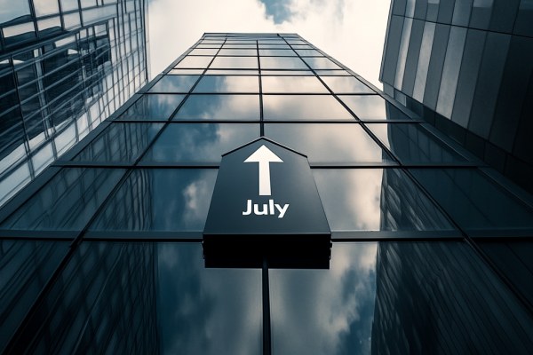 The word July with an arrow pointing up above it on the side of an office building