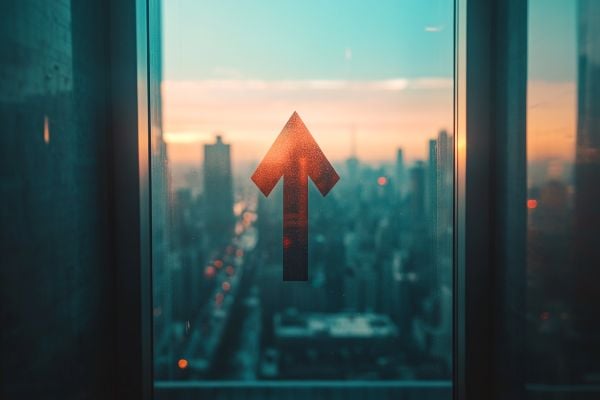 red arrow going up on a window overlooking a city