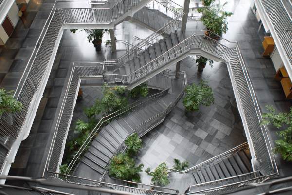 MC Escher-style staircases in a modern corporate building lobby