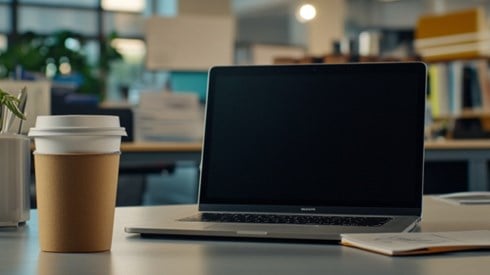 Laptop on a desk with coffee