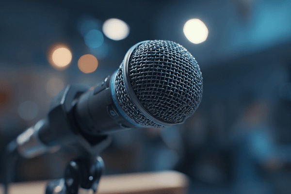 A close-up of a microphone on a speaker’s podium