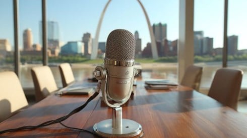 a microphone sitting on a conference table in an office overlooking the St Louis Arch