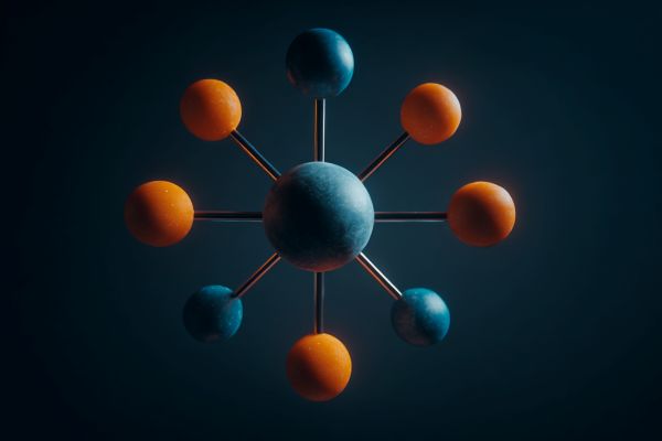 one large blue sphere with 8 smaller blue and orange spheres attached to it