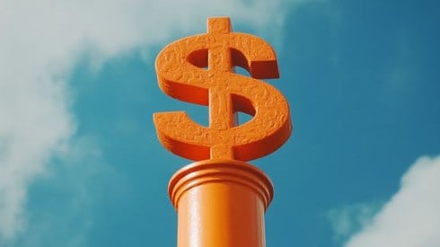 orange dollar sign on an orange column in front of a blue sky