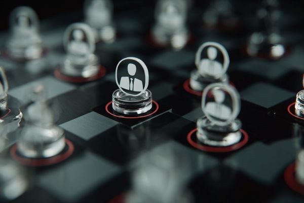 businesspeople icons as clear disc game pieces on a checkerboard game
