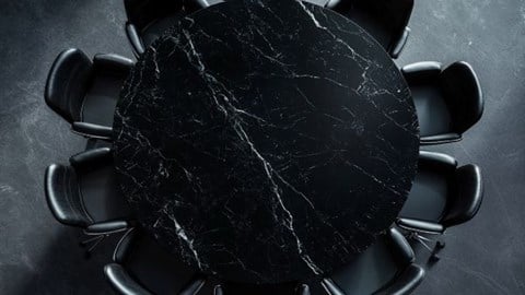 overhead view of a round black conference table and chairs