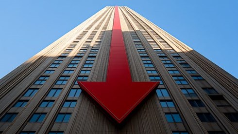 A red arrow pointing down on the side of a skyscraper