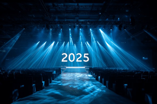 The number 2025 on a stage with spotlights shining above it