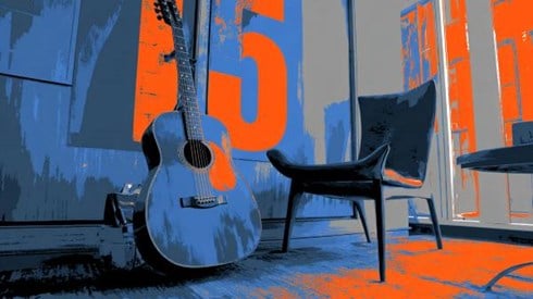 stylized photo of a blue guitar leaning up against a blue and orange wall with the number "15" on it next to a chair