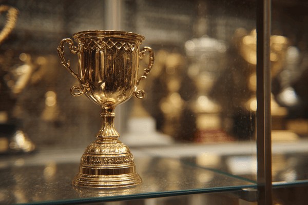 A gold trophy in a trophy case