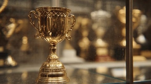 A gold trophy in a trophy case