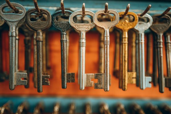 vintage brass keys hanging on an orange and turquoise wall