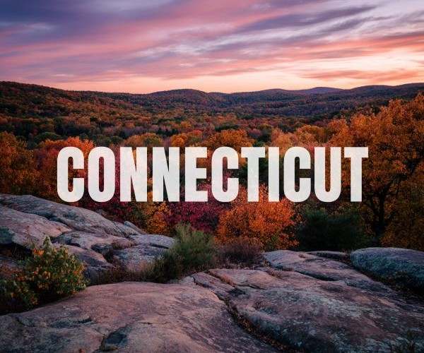 the word "CONNECTICUT" superimposed over a view of the Connecticut mountains and boulders at sunrise