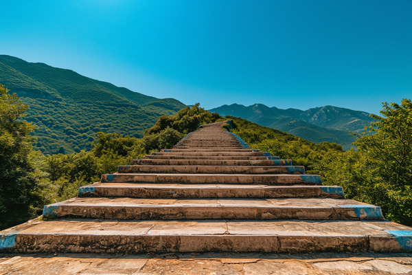A stone staircase leading up through verdant mountains