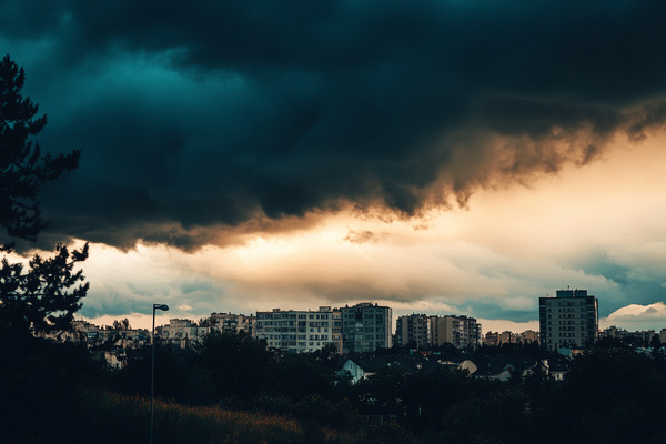 Dark storm clouds forming over a city.