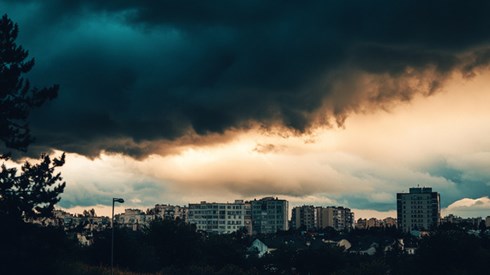Dark storm clouds forming over a city.