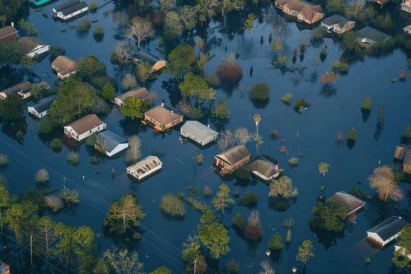 An aerial view of an entire neighborhood under flood waters