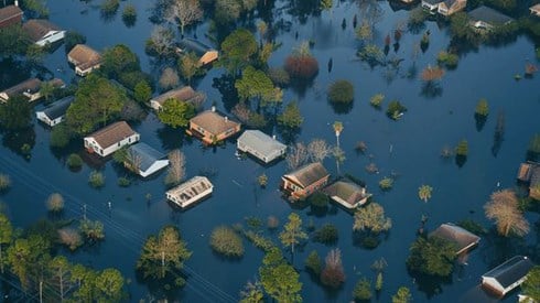 An aerial view of an entire neighborhood under flood waters