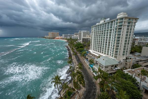 hurricane stormclouds approaching Hawaiian hotel and coastline