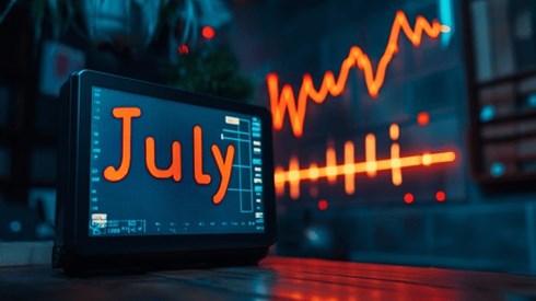 July on a monitor in front of an ascending graph and a stable line graph