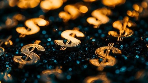 closeup of tiny gold dollar signs