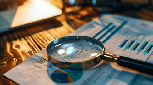 Magnifying glass on top of a report