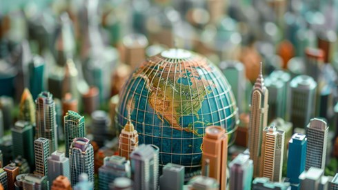 A small globe resting in the middle of a collection of multicolored miniature skyscrapers and corporate buildings.