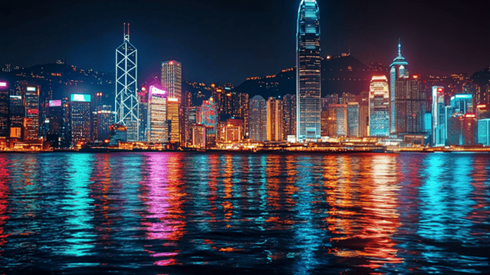 Downtown Hong Kong at night, with its colorful lights reflecting in the water