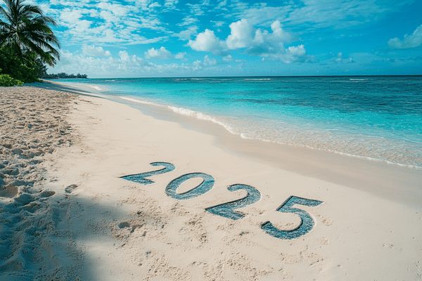 The number 2025 in the sand of a beach on the Cayman Islands