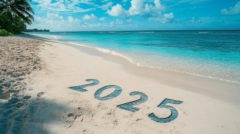 The number 2025 in the sand of a beach on the Cayman Islands