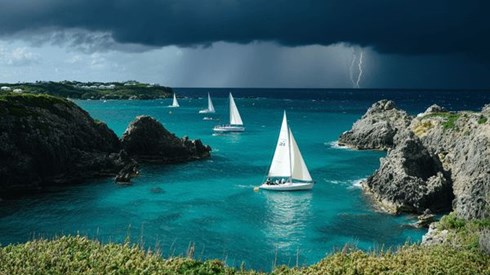 Sailboats off the coast of Bermuda with a thunderstorm on the horizon