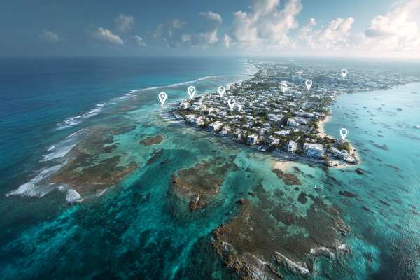 overhead view of Cayman Islands with digital white map markers superimposed over the island