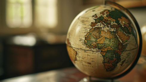 Globe focusing on Europe, Africa, and the Middle East sitting on a wooden table