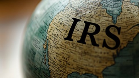 A globe with the letters "IRS" over the United States